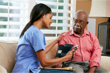 senior man at home with a nurse